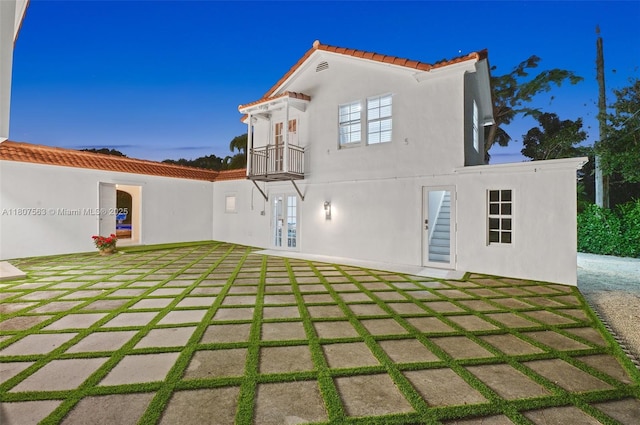 321 SW 1st Ave, Boynton Beach, FL 33435 - rear view of property with a tiled roof, stucco siding, a balcony, a patio area, and french doors