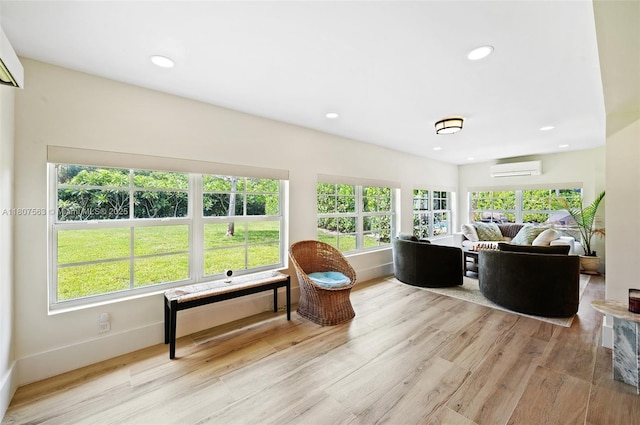 321 SW 1st Ave, Boynton Beach, FL 33435 - living room featuring a wall mounted AC, light wood-style floors, healthy amount of natural light, and recessed lighting