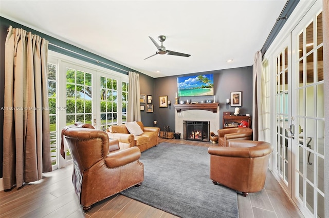 321 SW 1st Ave, Boynton Beach, FL 33435 - living area with french doors, ceiling fan, wood finished floors, a fireplace with flush hearth, and recessed lighting