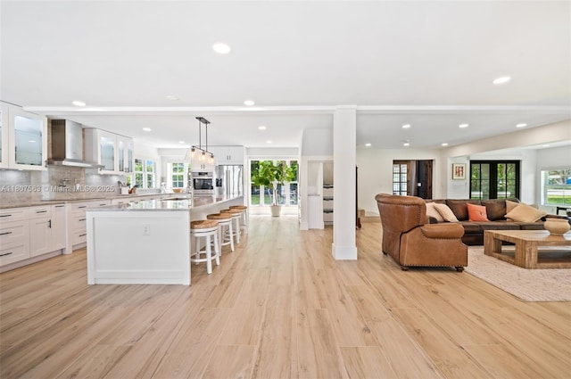 321 SW 1st Ave, Boynton Beach, FL 33435 - living room with light wood-style flooring, recessed lighting, and plenty of natural light
