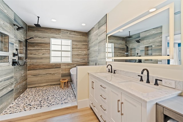 321 SW 1st Ave, Boynton Beach, FL 33435 - full bath with a walk in shower, double vanity, a soaking tub, wood finished floors, and recessed lighting