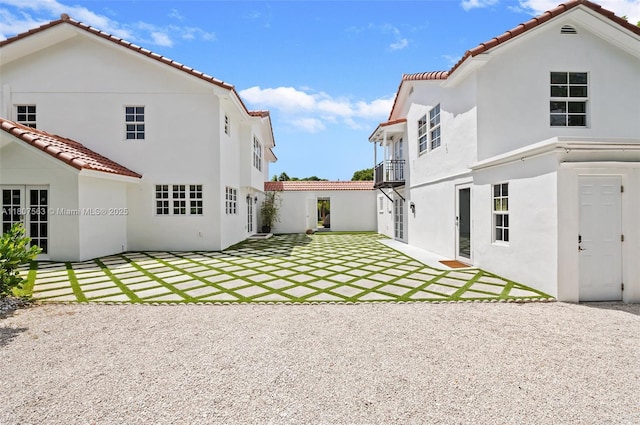 321 SW 1st Ave, Boynton Beach, FL 33435 - rear view of house featuring a tiled roof, a patio, and stucco siding