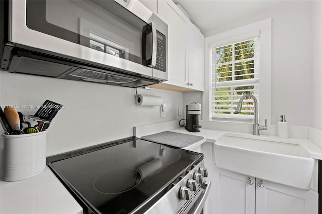 321 SW 1st Ave, Boynton Beach, FL 33435 - kitchen featuring appliances with stainless steel finishes, white cabinetry, and light countertops