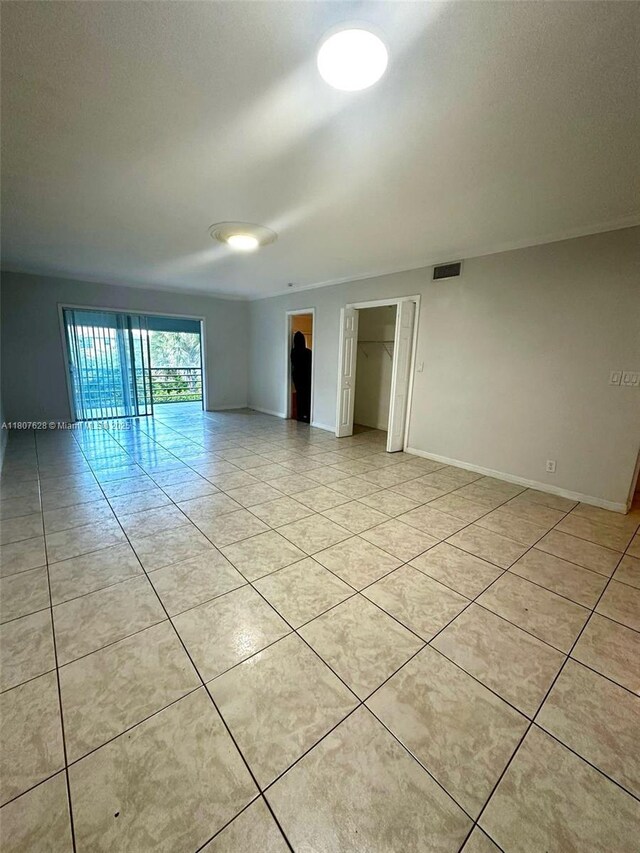 4291 NW 9th Ave Unit 202, Deerfield Beach, FL 33064 - empty room with light tile patterned floors and baseboards
