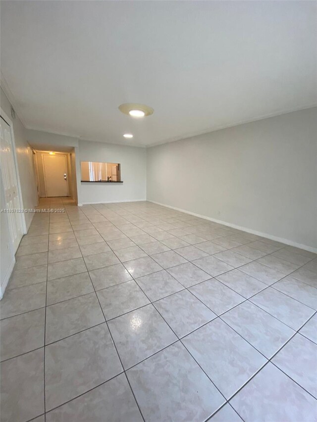 4291 NW 9th Ave Unit 202, Deerfield Beach, FL 33064 - empty room with light tile patterned floors and baseboards