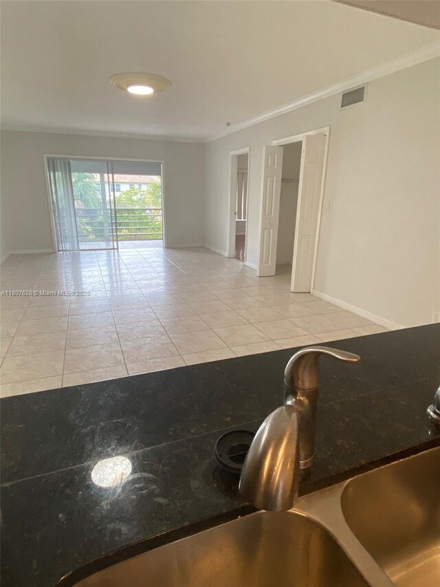 4291 NW 9th Ave Unit 202, Deerfield Beach, FL 33064 - tiled empty room with a sink, ornamental molding, and baseboards