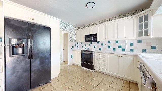 17535 SW 91st Ave, Palmetto Bay, FL 33157 - kitchen featuring black appliances, tile countertops, white cabinetry, glass insert cabinets, and light tile patterned floors