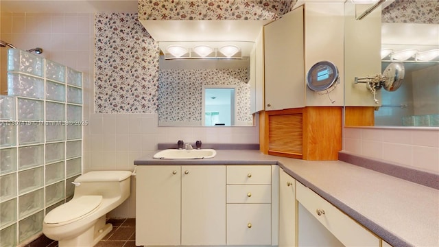17535 SW 91st Ave, Palmetto Bay, FL 33157 - bathroom with wallpapered walls, walk in shower, vanity, tile walls, and tile patterned floors