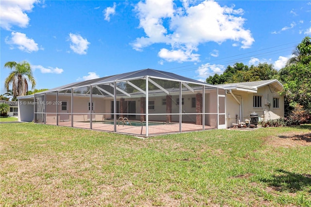 17535 SW 91st Ave, Palmetto Bay, FL 33157 - back of property featuring a lawn, a patio area, glass enclosure, and stucco siding