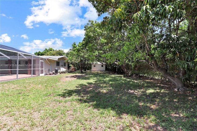 17535 SW 91st Ave, Palmetto Bay, FL 33157 - view of grassy yard with a storage shed and a lanai