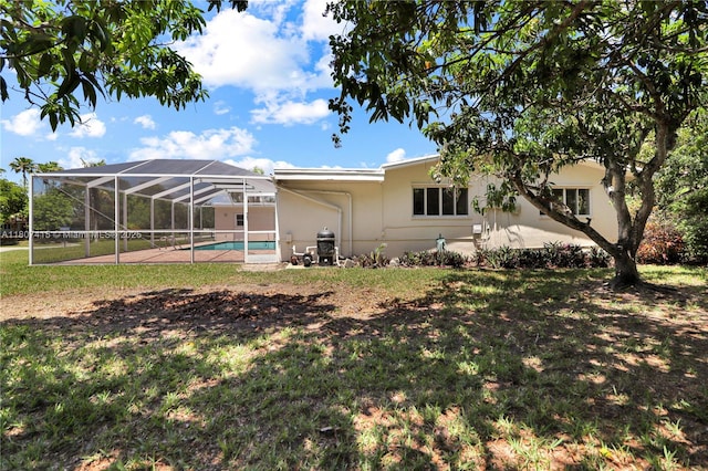 17535 SW 91st Ave, Palmetto Bay, FL 33157 - rear view of house featuring an outdoor pool, a lawn, a patio area, and a lanai