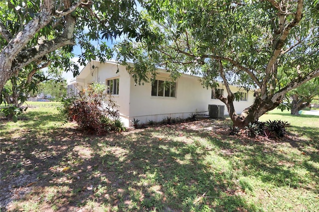 17535 SW 91st Ave, Palmetto Bay, FL 33157 - view of side of home featuring a central air condition unit and a yard