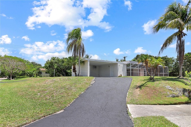 17535 SW 91st Ave, Palmetto Bay, FL 33157 - view of front of house with asphalt driveway, a carport, and a front lawn