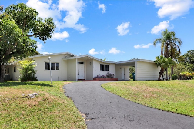 17535 SW 91st Ave, Palmetto Bay, FL 33157 - ranch-style home with driveway, a front lawn, stucco siding, and an attached carport