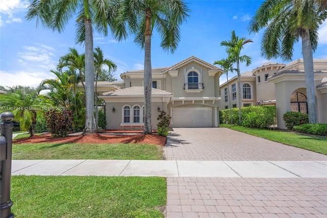 9839 Palma Vista Way, Boca Raton, FL 33428 - mediterranean / spanish house with decorative driveway, stucco siding, an attached garage, a tile roof, and a front lawn