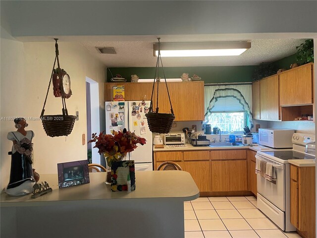 11753 SW 32nd St, Miami, FL 33175 - kitchen with white appliances, light tile patterned floors, a sink, light countertops, and a textured ceiling