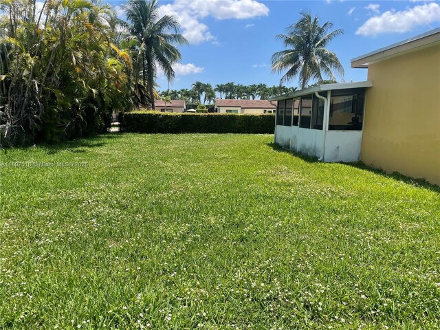 11753 SW 32nd St, Miami, FL 33175 - view of grassy yard with a sunroom