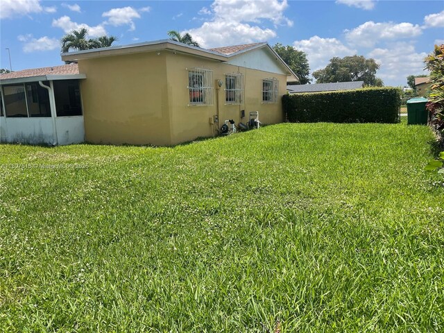 11753 SW 32nd St, Miami, FL 33175 - view of green lawn featuring a sunroom