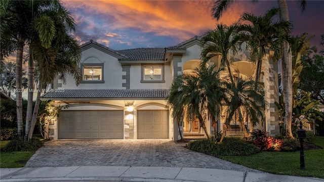 3905 Pinecrest Ct, Weston, FL 33331 - mediterranean / spanish home with stucco siding, an attached garage, driveway, and a tiled roof