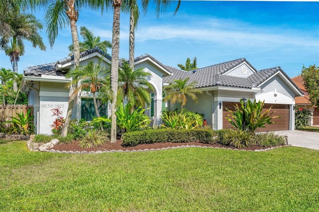 6121 Superior Blvd, Davie, FL 33331 - view of front of property with stucco siding, a tile roof, a garage, and driveway