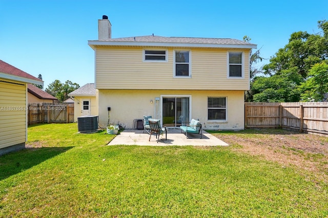 879 Matt Ln, Port Orange, FL 32127 - rear view of property with central AC unit, a chimney, a patio area, and stucco siding