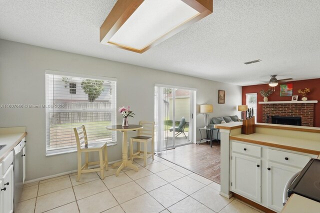 879 Matt Ln, Port Orange, FL 32127 - kitchen featuring white cabinetry, a ceiling fan, a textured ceiling, light countertops, and electric range
