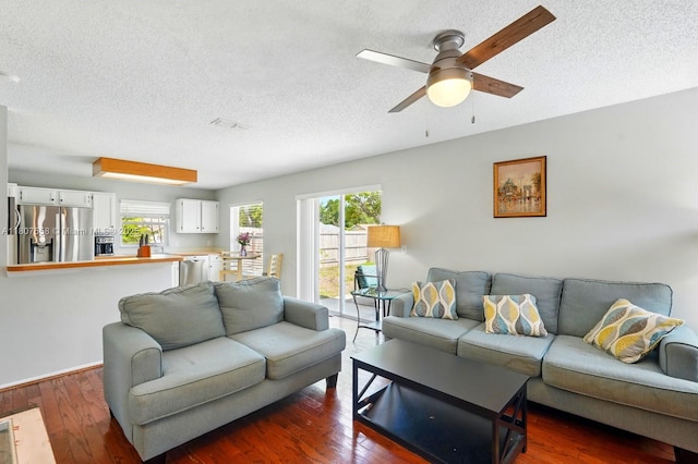 879 Matt Ln, Port Orange, FL 32127 - living room featuring a textured ceiling, ceiling fan, and dark wood-style flooring