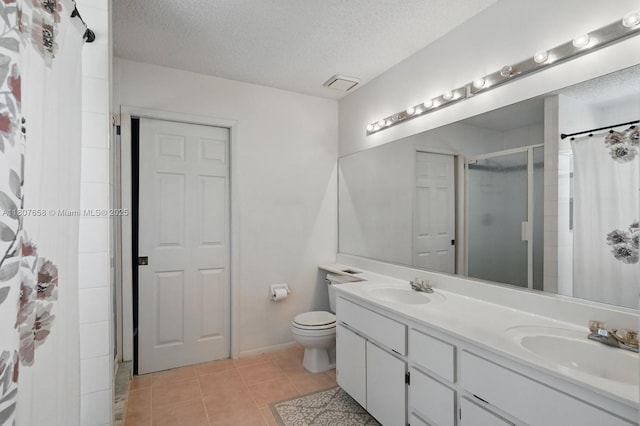 879 Matt Ln, Port Orange, FL 32127 - bathroom featuring a textured ceiling, a shower with curtain, tile patterned floors, double vanity, and toilet