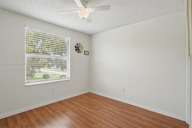 879 Matt Ln, Port Orange, FL 32127 - unfurnished room featuring a textured ceiling, wood finished floors, ceiling fan, and baseboards