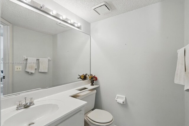 879 Matt Ln, Port Orange, FL 32127 - bathroom featuring a textured ceiling, toilet, and vanity