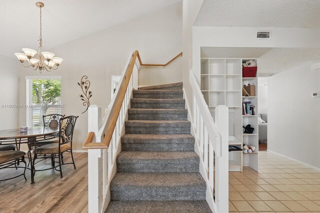 879 Matt Ln, Port Orange, FL 32127 - staircase featuring a chandelier, a textured ceiling, and baseboards