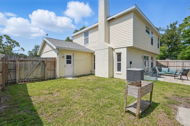 879 Matt Ln, Port Orange, FL 32127 - rear view of property featuring cooling unit, an outdoor living space, stucco siding, a patio, and a chimney