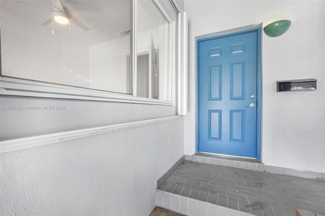 9710 Haitian Dr, Cutler Bay, FL 33189 - view of exterior entry featuring ceiling fan and stucco siding
