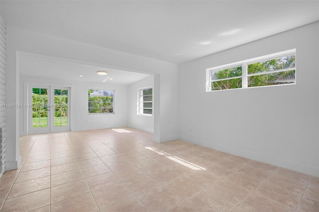 9710 Haitian Dr, Cutler Bay, FL 33189 - empty room featuring healthy amount of natural light, light tile patterned flooring, and baseboards