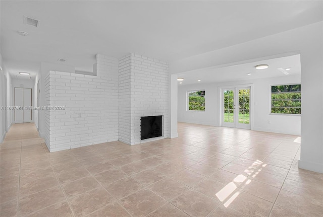 9710 Haitian Dr, Cutler Bay, FL 33189 - unfurnished living room with light tile patterned floors, healthy amount of natural light, a fireplace, and recessed lighting