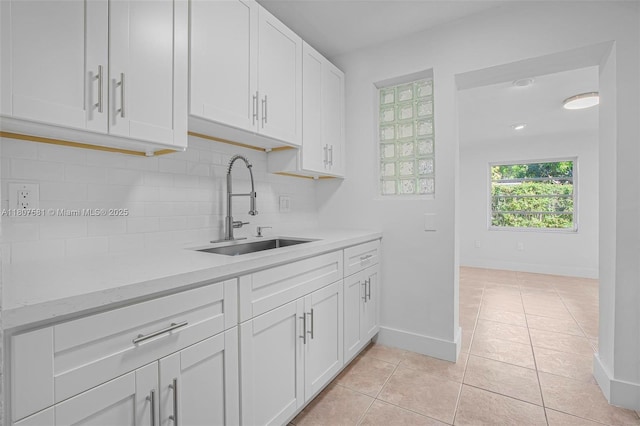 9710 Haitian Dr, Cutler Bay, FL 33189 - kitchen featuring a sink, tasteful backsplash, white cabinets, baseboards, and light tile patterned floors