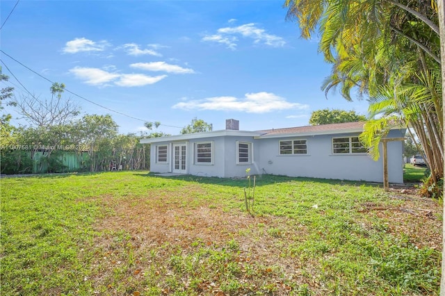9710 Haitian Dr, Cutler Bay, FL 33189 - back of property with stucco siding, a lawn, and a chimney