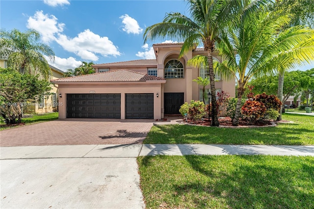 13366 NW 14th St, Pembroke Pines, FL 33028 - mediterranean / spanish house featuring decorative driveway, stucco siding, a tile roof, an attached garage, and a front lawn