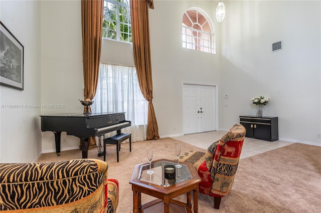 13366 NW 14th St, Pembroke Pines, FL 33028 - living room featuring light carpet, a towering ceiling, and baseboards