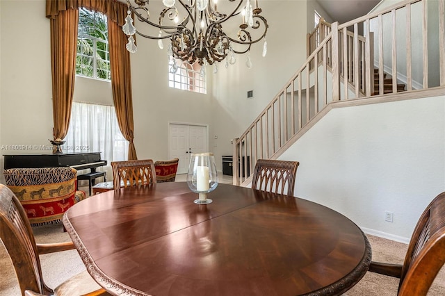 13366 NW 14th St, Pembroke Pines, FL 33028 - carpeted dining room featuring stairs, healthy amount of natural light, a chandelier, baseboards, and a high ceiling