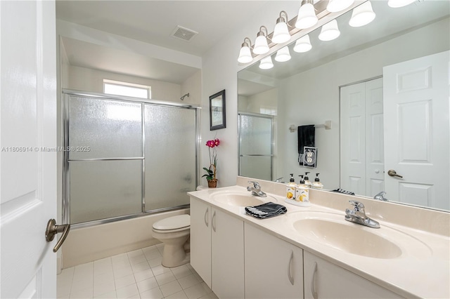 13366 NW 14th St, Pembroke Pines, FL 33028 - bathroom featuring tile patterned floors, shower / bath combination with glass door, double vanity, and toilet
