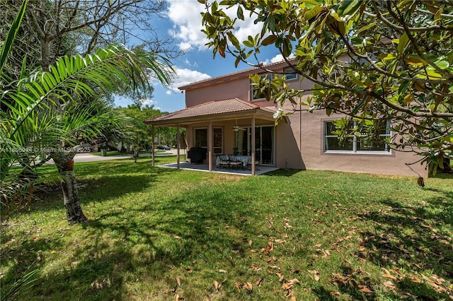 13366 NW 14th St, Pembroke Pines, FL 33028 - back of house with stucco siding, a patio, a yard, and a tile roof