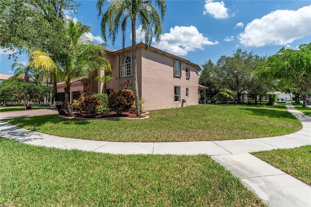 13366 NW 14th St, Pembroke Pines, FL 33028 - view of property exterior with stucco siding and a yard