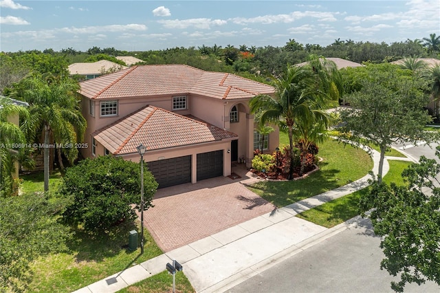 13366 NW 14th St, Pembroke Pines, FL 33028 - mediterranean / spanish home with a garage, stucco siding, a tiled roof, decorative driveway, and a front lawn