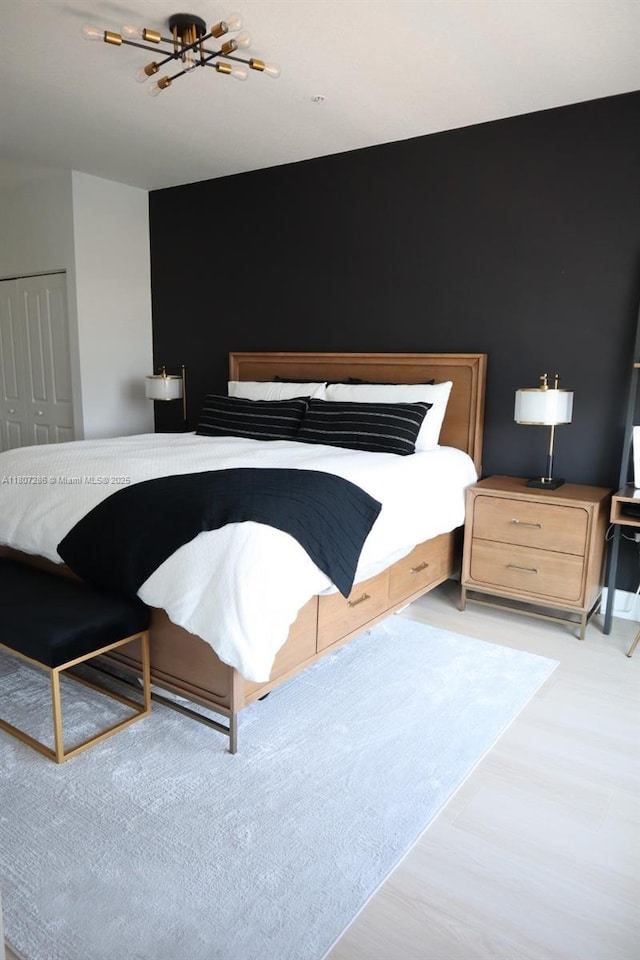 8201 NW 41st St Unit D-402, Doral, FL 33166 - bedroom featuring light wood-style flooring, a chandelier, and a closet