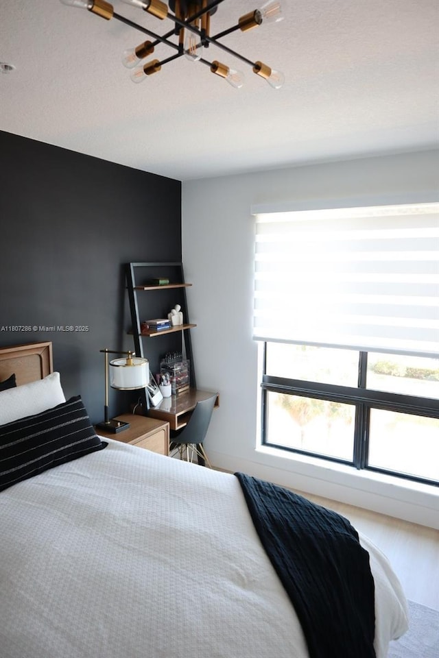 8201 NW 41st St Unit D-402, Doral, FL 33166 - bedroom featuring a chandelier