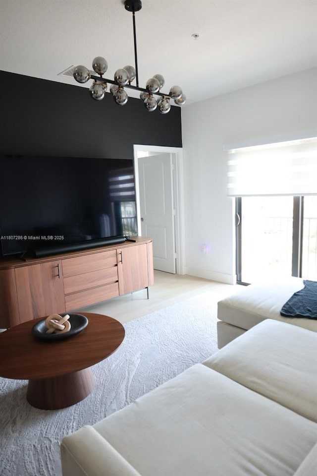 8201 NW 41st St Unit D-402, Doral, FL 33166 - living area featuring light colored carpet and a chandelier