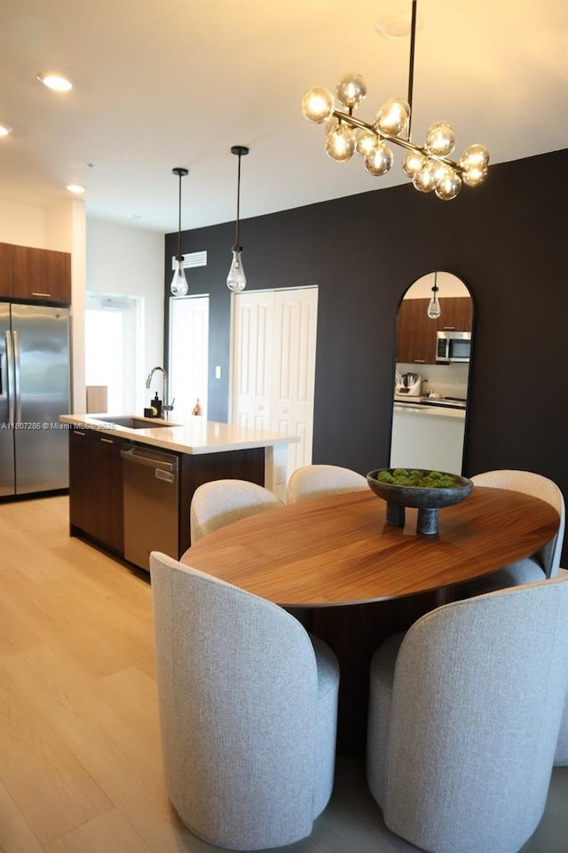 8201 NW 41st St Unit D-402, Doral, FL 33166 - dining area with light wood-style floors, arched walkways, and a chandelier