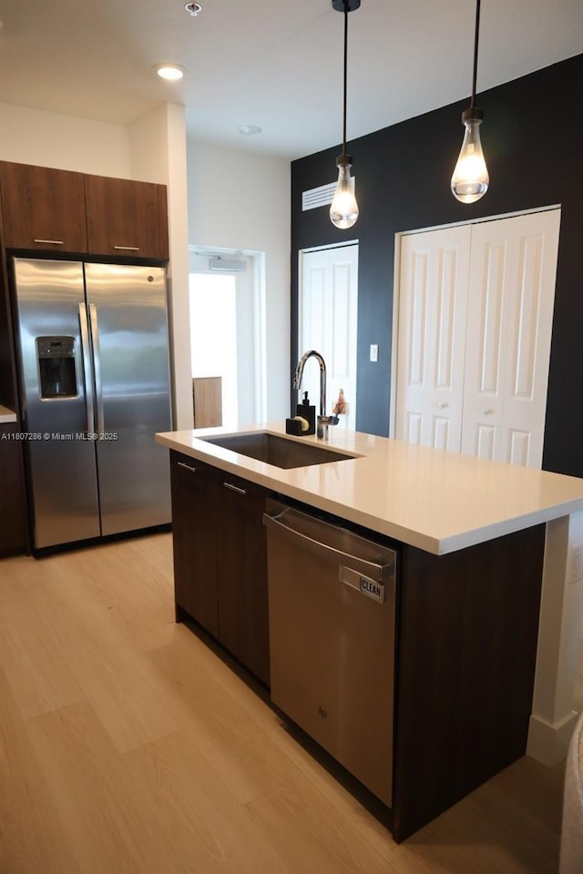 8201 NW 41st St Unit D-402, Doral, FL 33166 - kitchen featuring appliances with stainless steel finishes, a sink, dark brown cabinets, light countertops, and recessed lighting