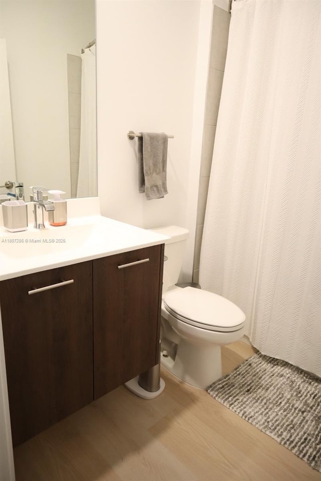 8201 NW 41st St Unit D-402, Doral, FL 33166 - bathroom featuring toilet, wood finished floors, vanity, and a shower with curtain